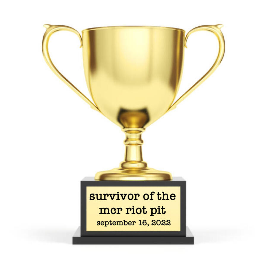 a trophy with the plaque reading “survivor of the mcr riot pit september 16, 2022”
