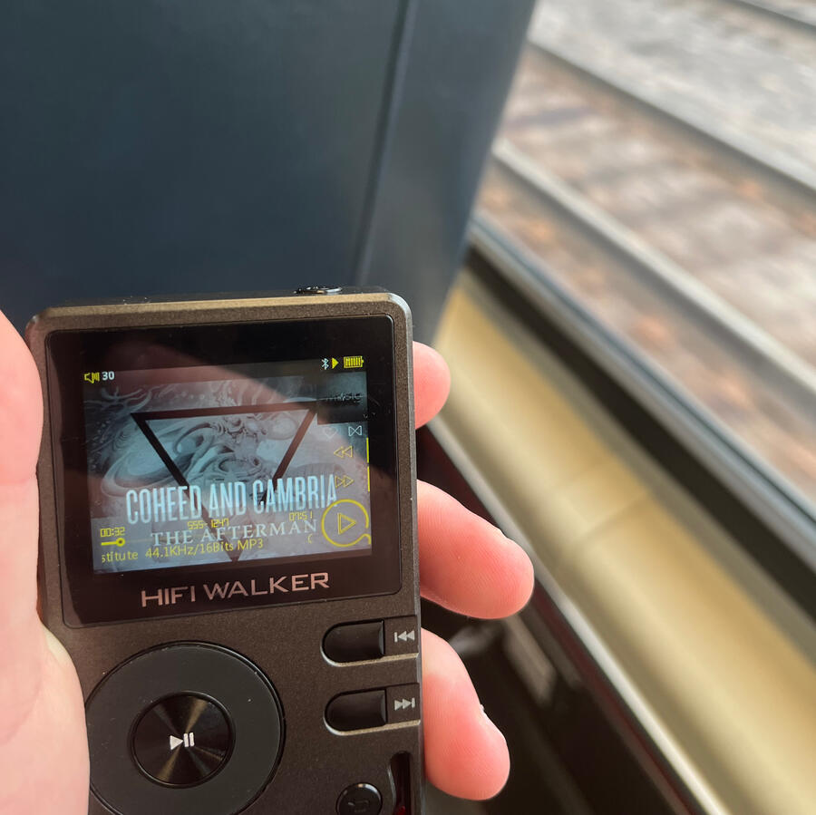 mp3 player an image taken of rain’s mp3 player sitting in their hand displaying the album cover of coheed and cambria’s “the afterman”